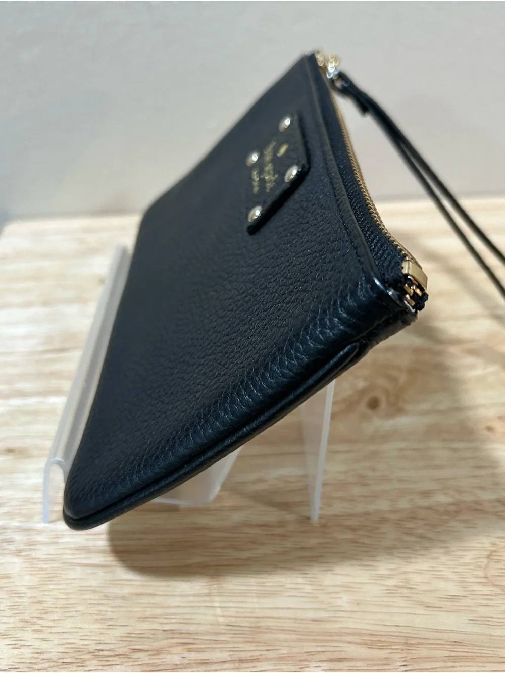 kate spade black pebbled leather wristlet with gold-tone logo